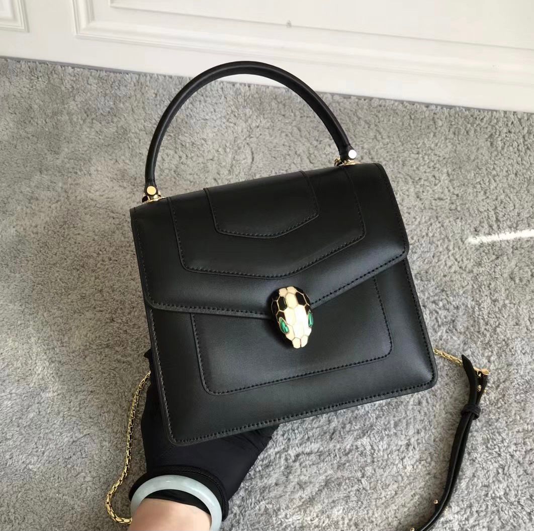 Bvlgari Serpenti Forever mini top handle bag in black calf leather with a light gold hardware snakehead closure. image 1