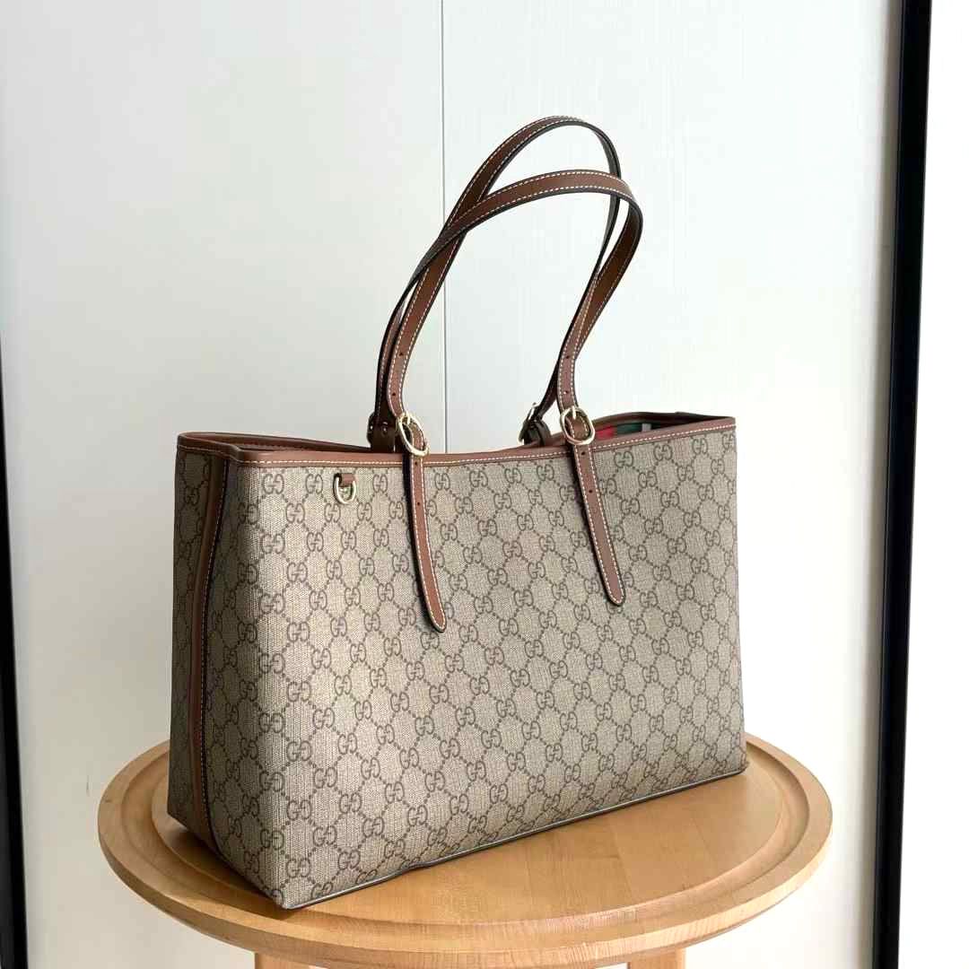 Gucci GG Emblem tote bag made from the brand's iconic monogrammed coated-canvas with contrasting leather trim. image 1