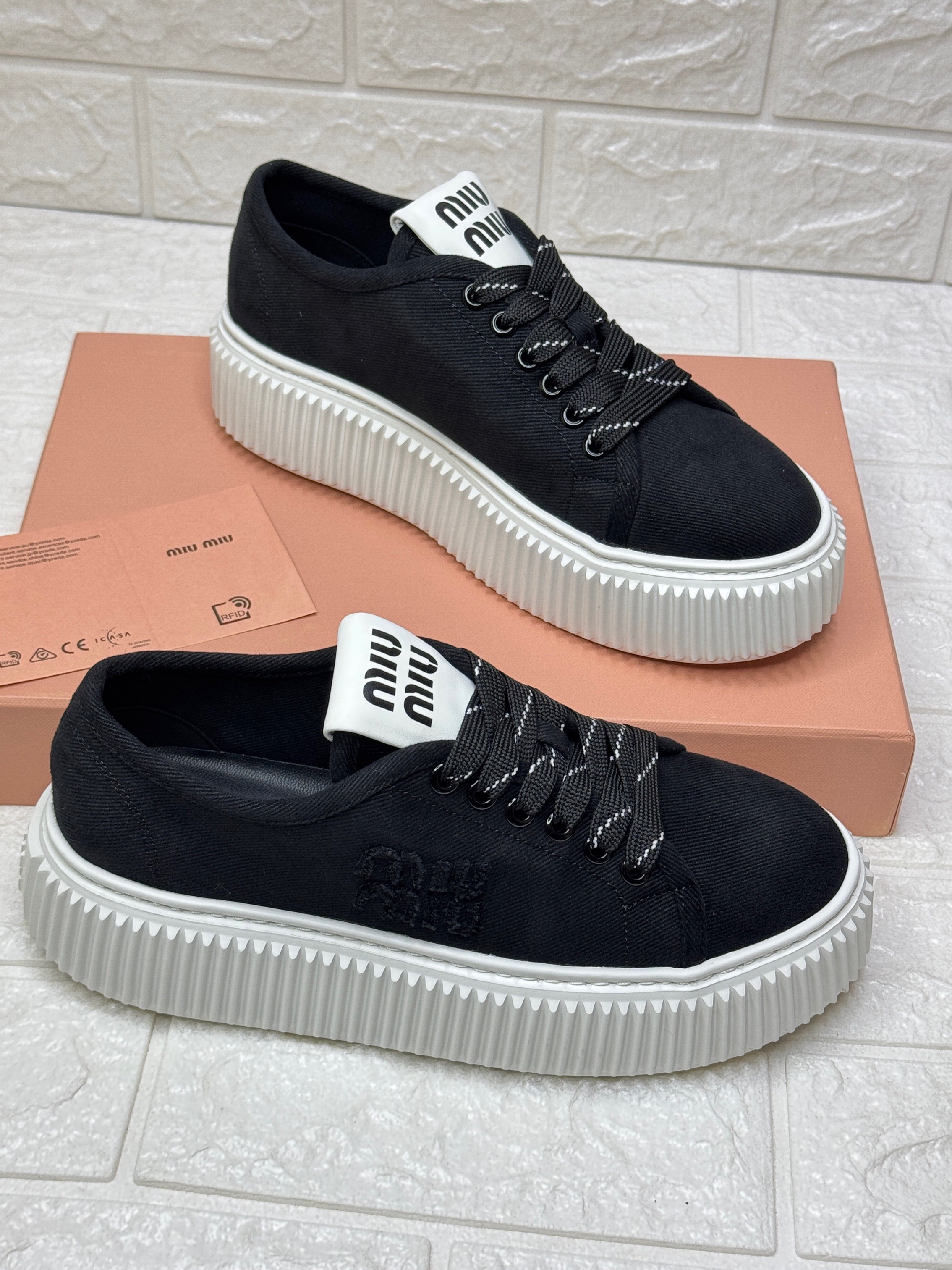 Miu Miu platform sneakers in black denim with a white, patterned rubber sole image 1