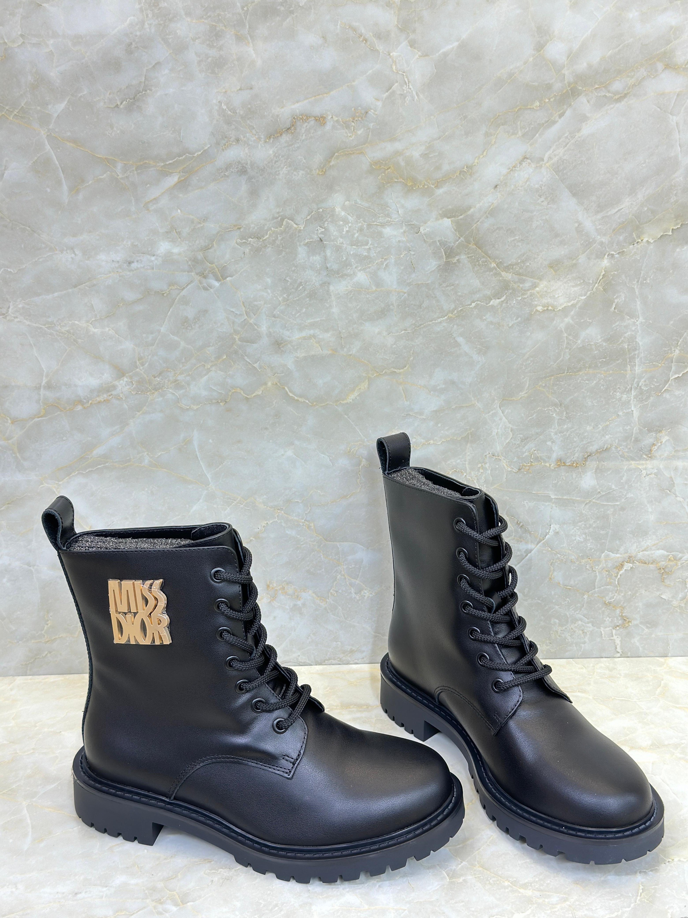 Dior D-Unit ankle boots with a gold-tone "Christian Dior Paris" signature on the side. image 1