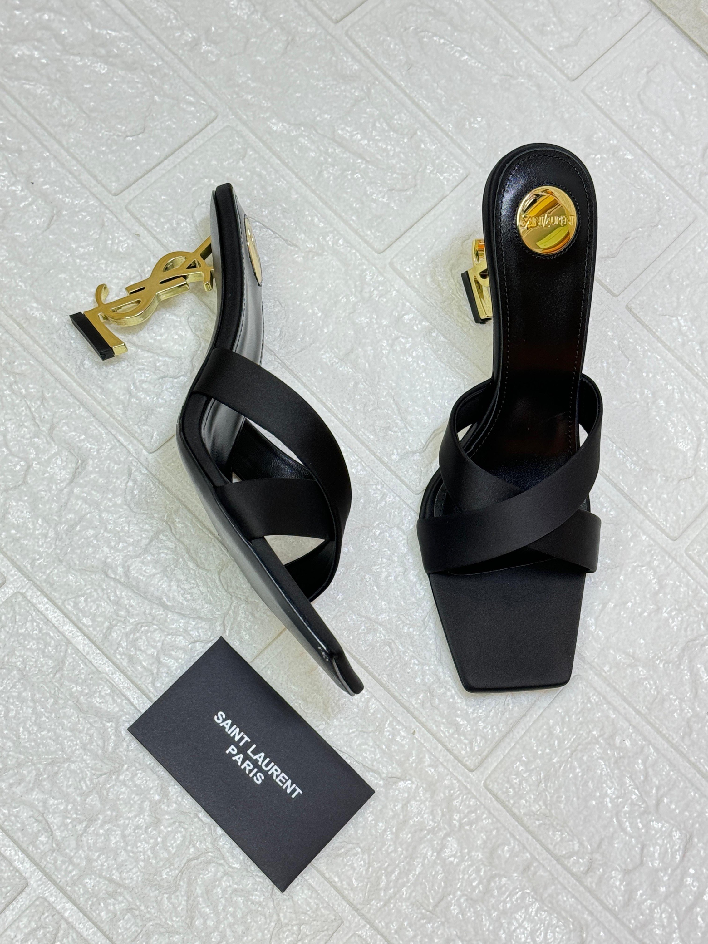 Saint Laurent Opyum 85 mule sandal in black satin crepe with a gold-tone Cassandre heel and crisscrossed straps. image 1