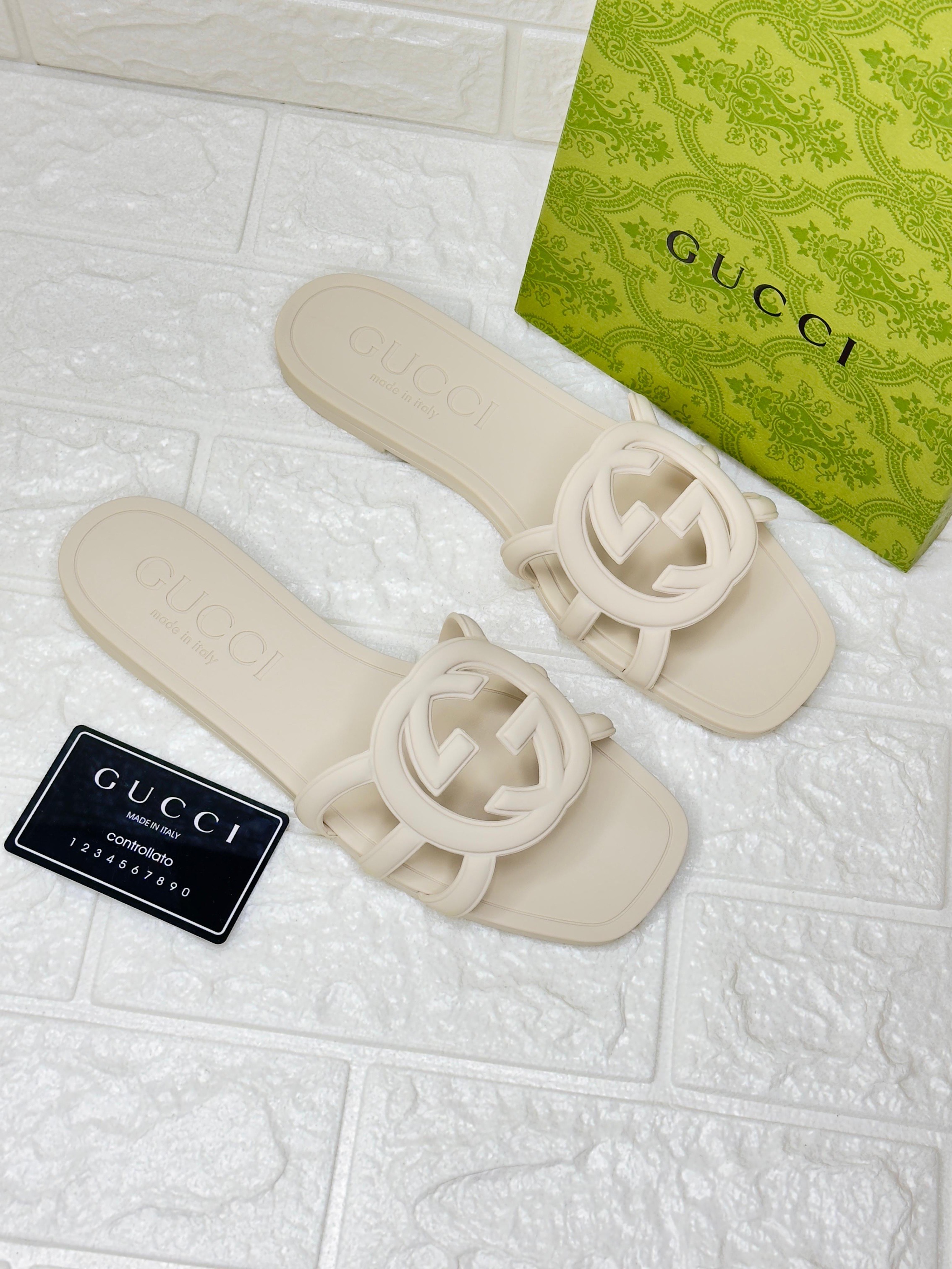 Gucci women's Interlocking G slide sandals in white or beige rubber. image 1