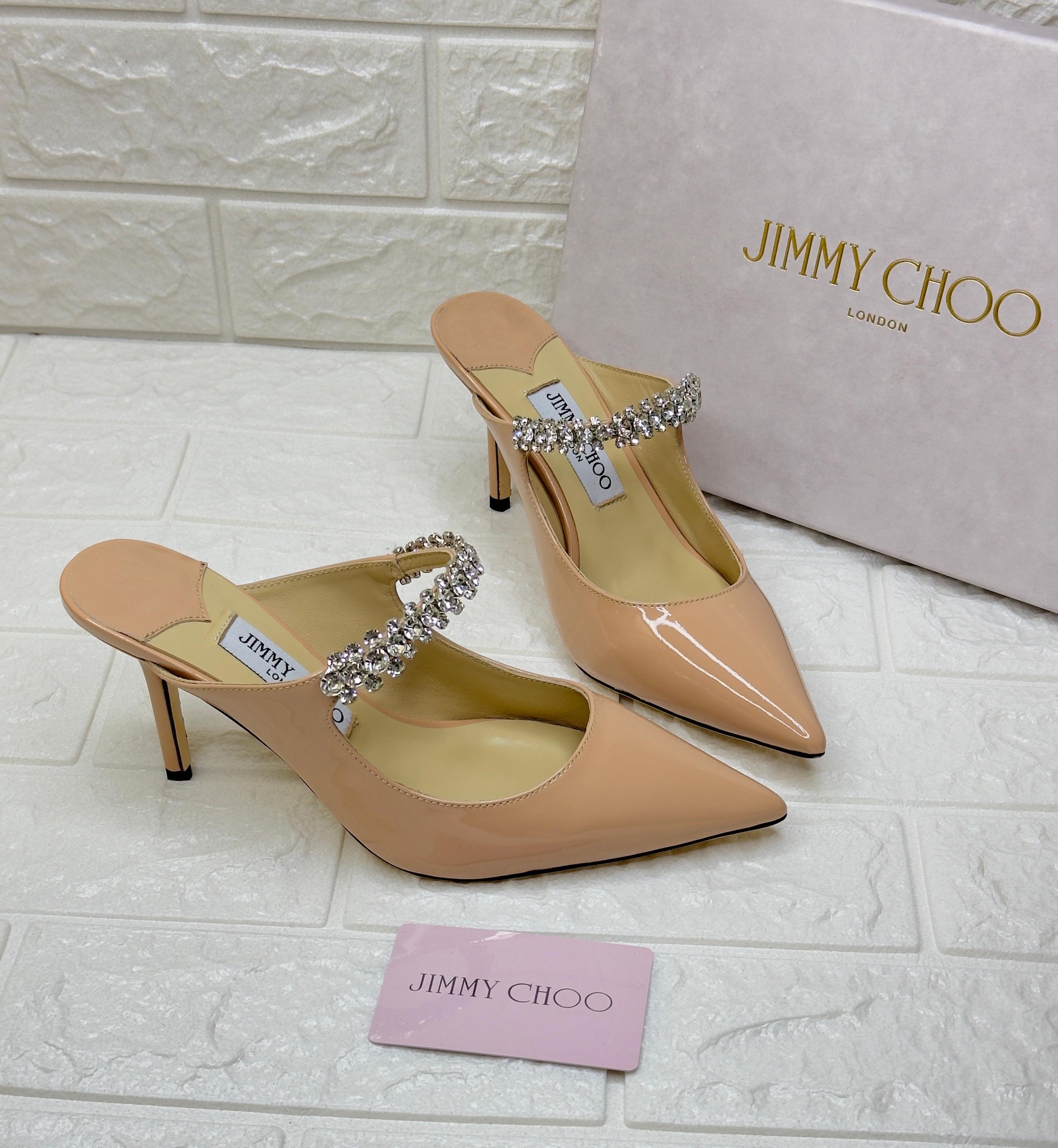 Jimmy Choo Bing 100 patent leather mule in a ballet pink or beige color with a crystal-embellished strap. image 1