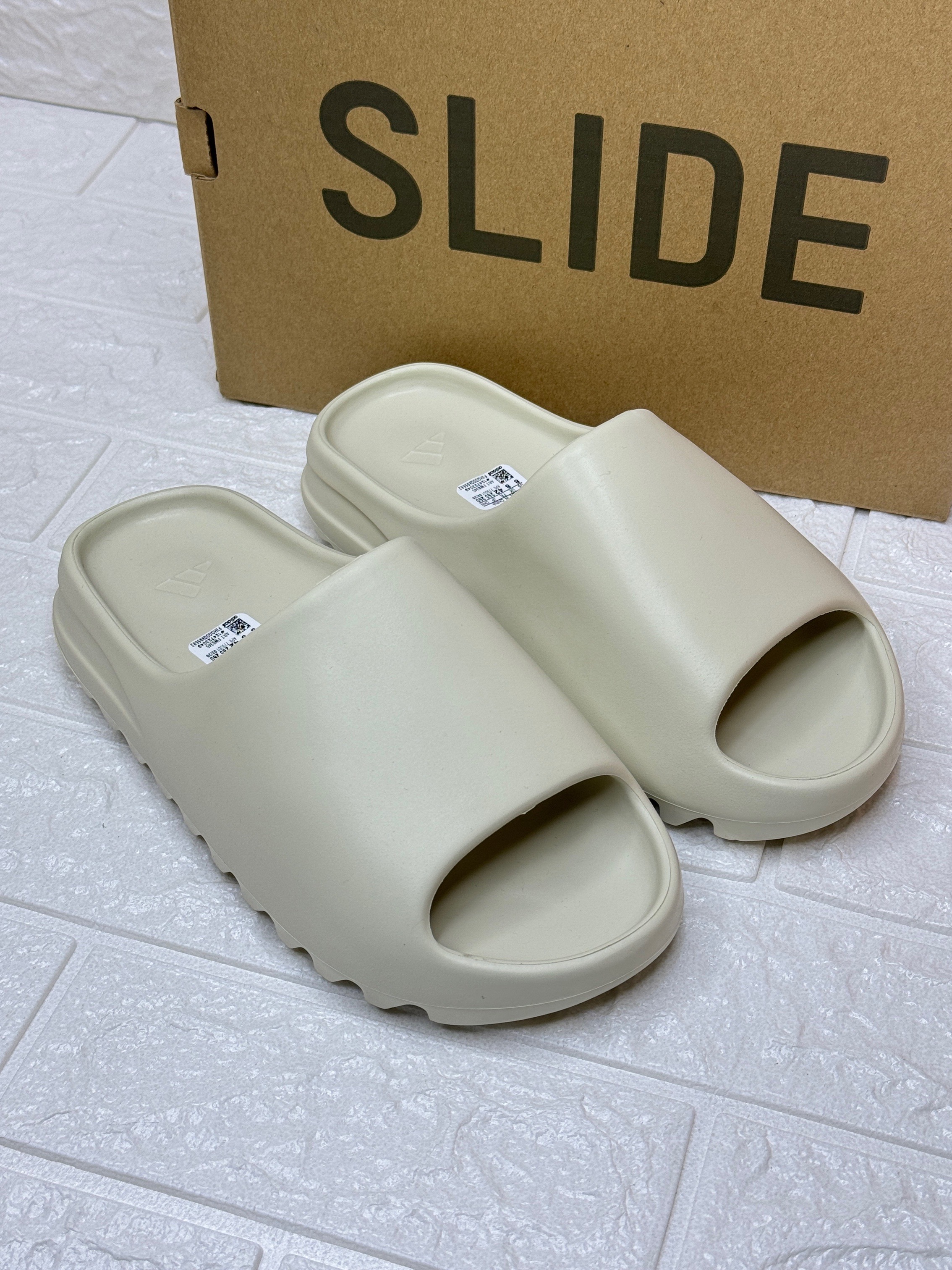 Adidas Yeezy Slide in a neutral colorway, potentially "Pure" or "Bone". image 1