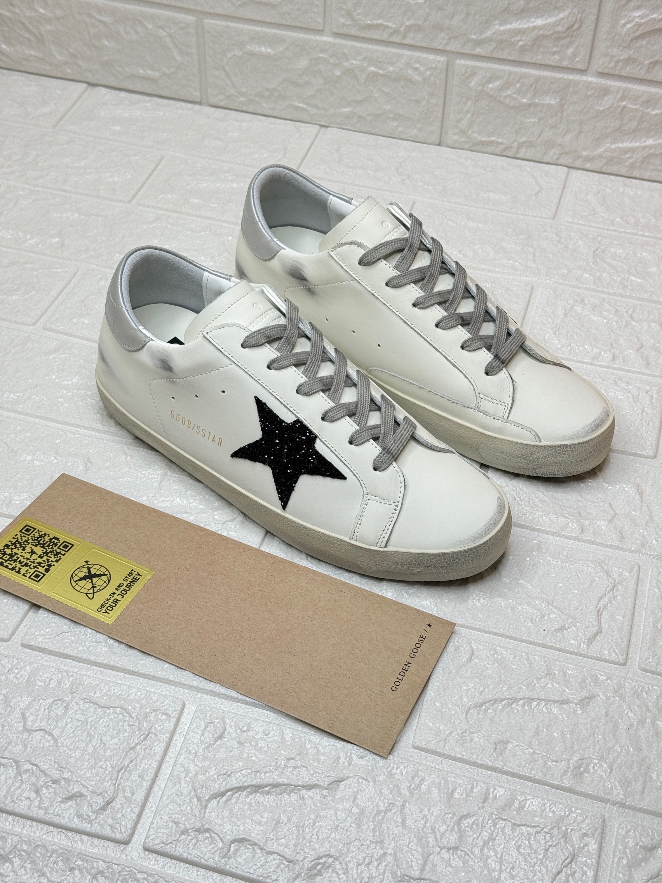 Golden Goose Super-Star sneakers, known for their signature distressed finish and star appliqué. image 1