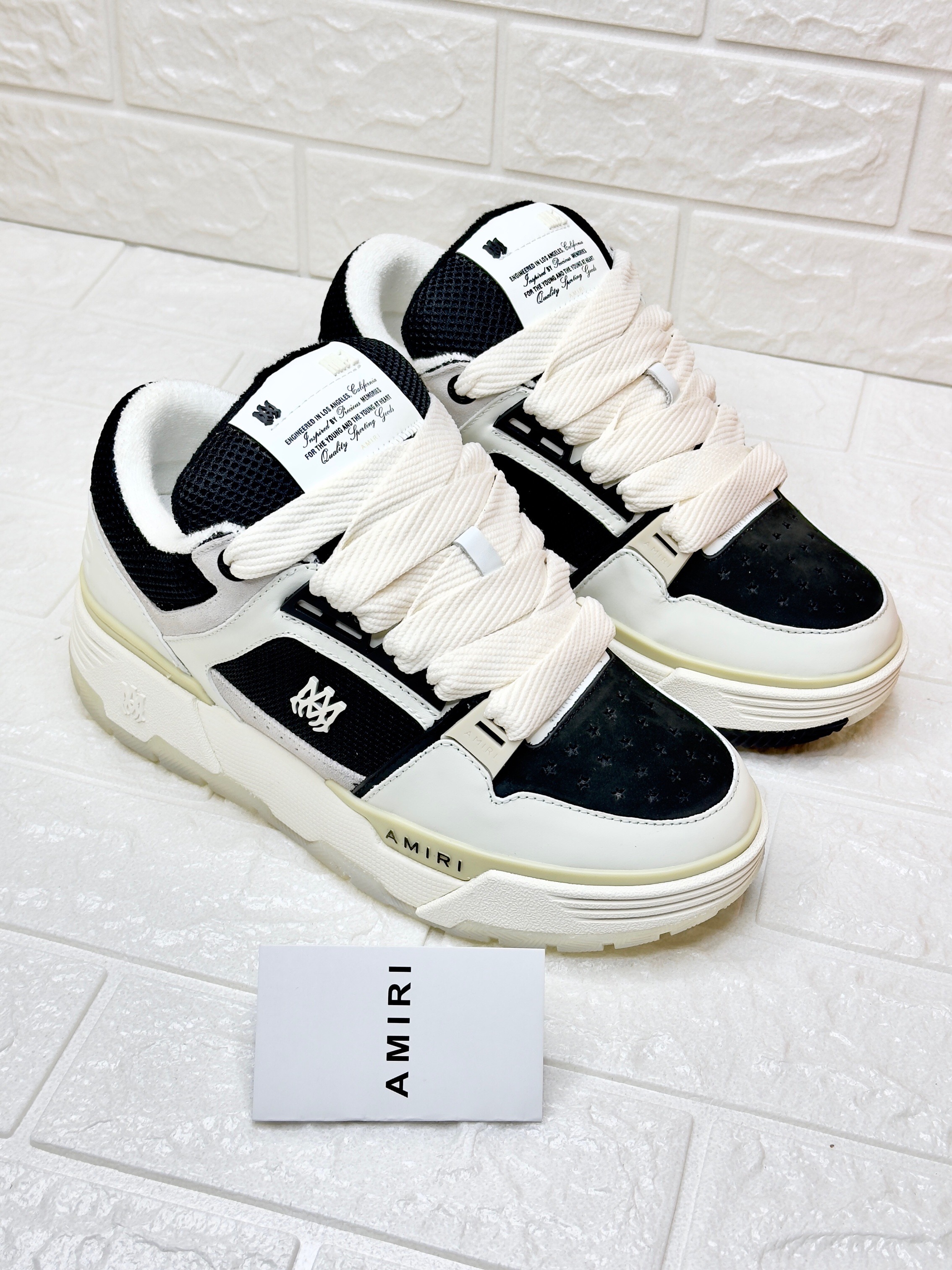 Amiri MA-1 sneaker in a white and black leather and mesh colorway. image 1