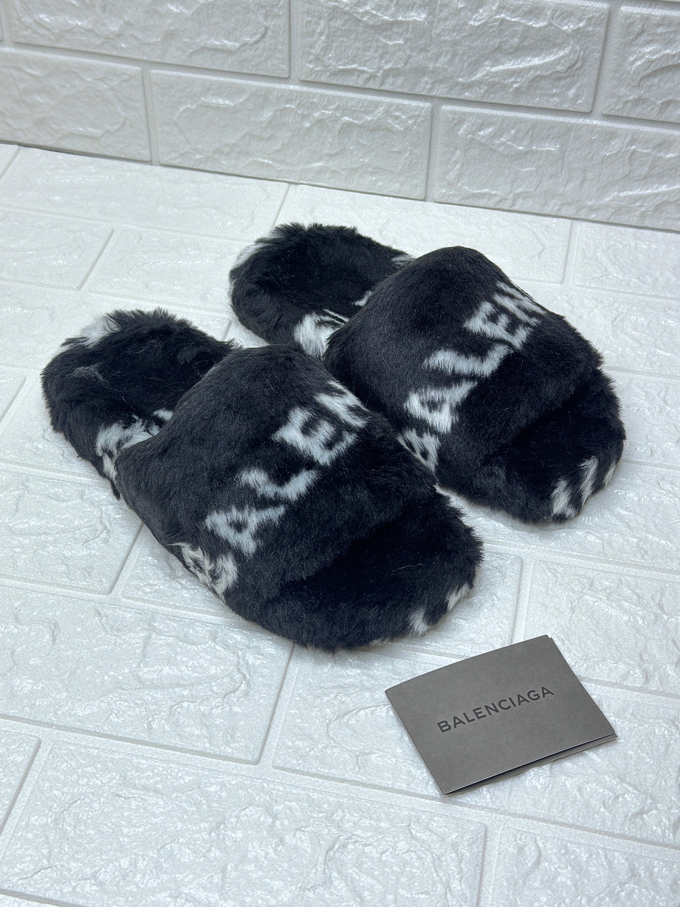 Balenciaga Furry Open Mule in black faux fur with a white allover logo pattern. image 1