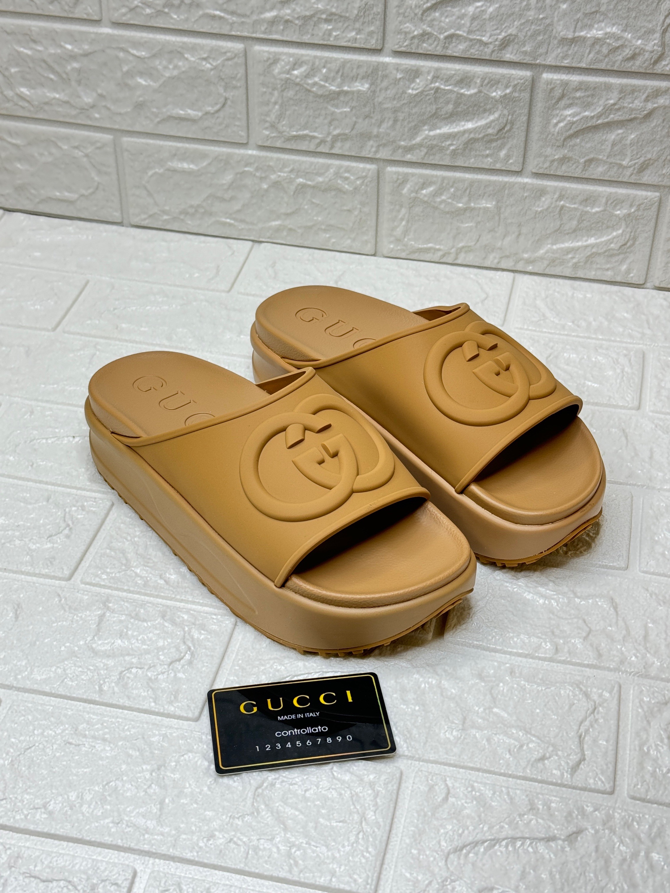 Gucci Interlocking G platform slide sandals in a camel or brown color. image 1