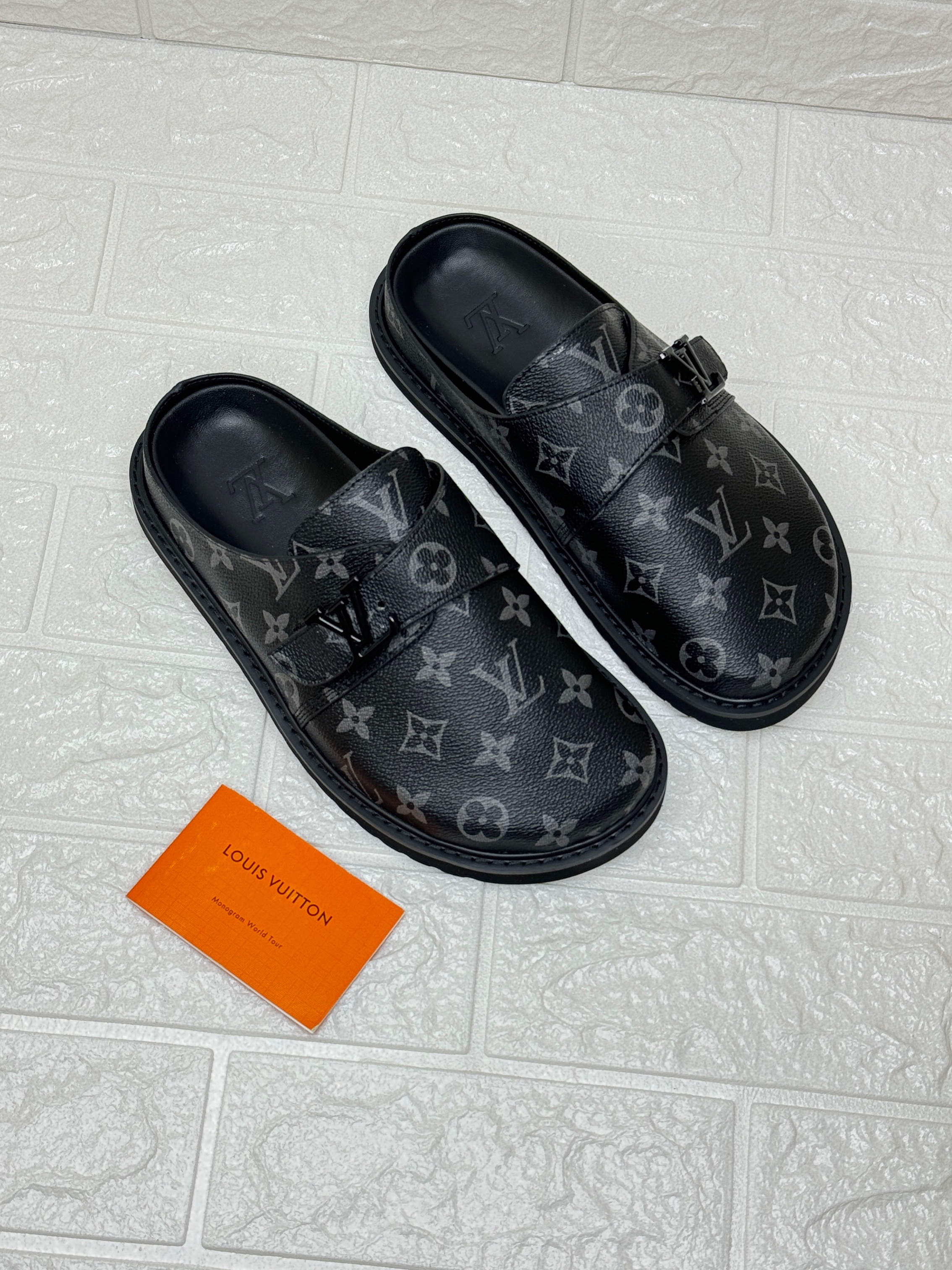Louis Vuitton LV Easy Mules in the black and grey Monogram colorway. image 1