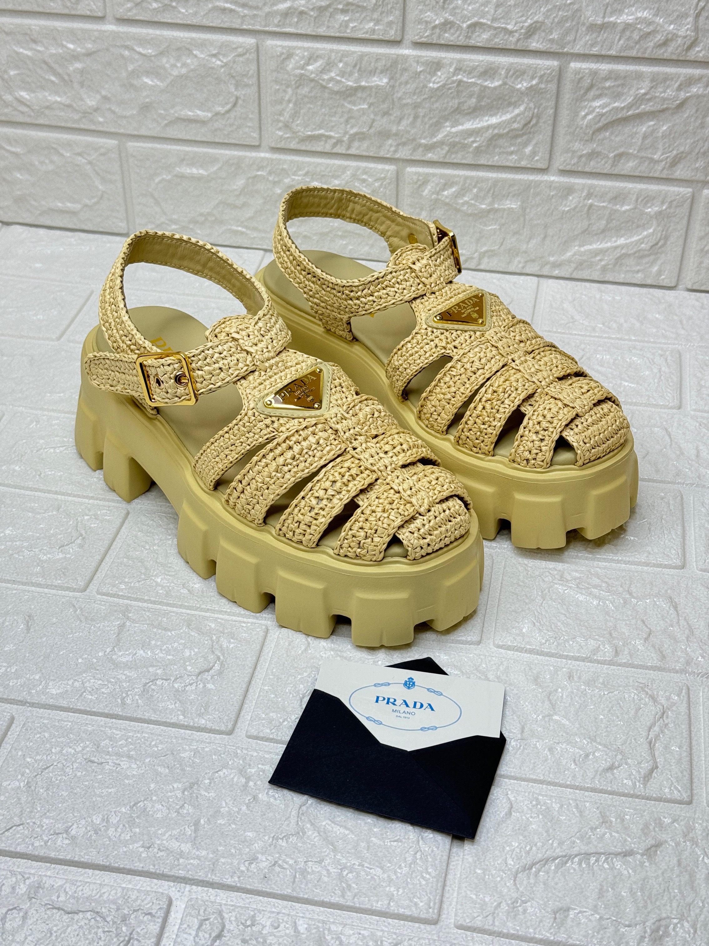 Prada Monolith logo-plaque chunky-sole caged crochet sandals in a neutral or beige khaki color. image 1
