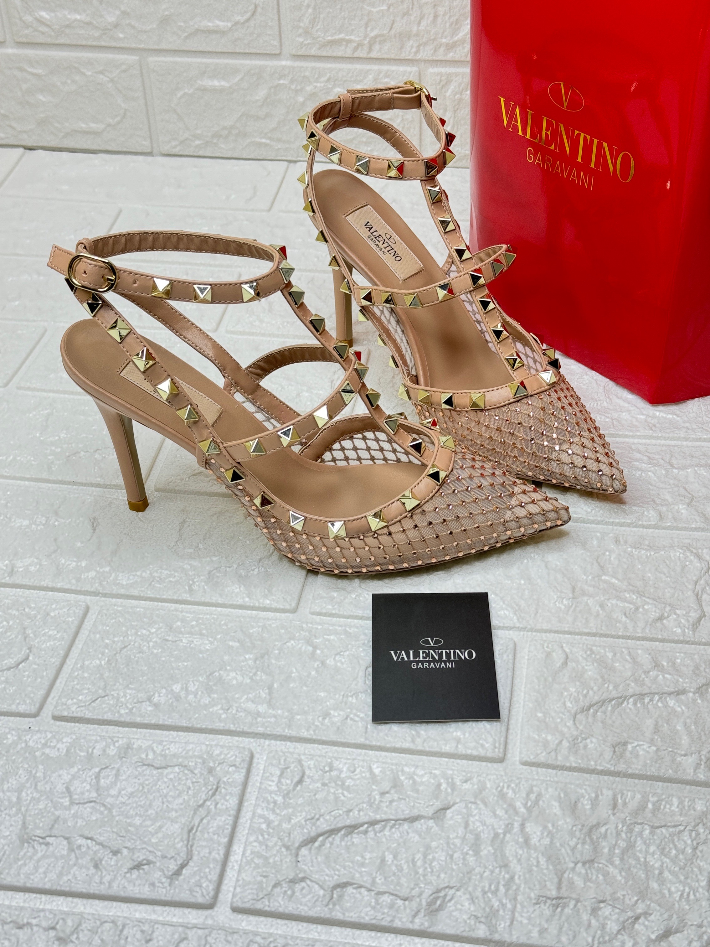 Valentino Garavani Rockstud pumps with a pointed toe, cage-like straps with pyramid-shaped studs, and a stiletto heel. image 1