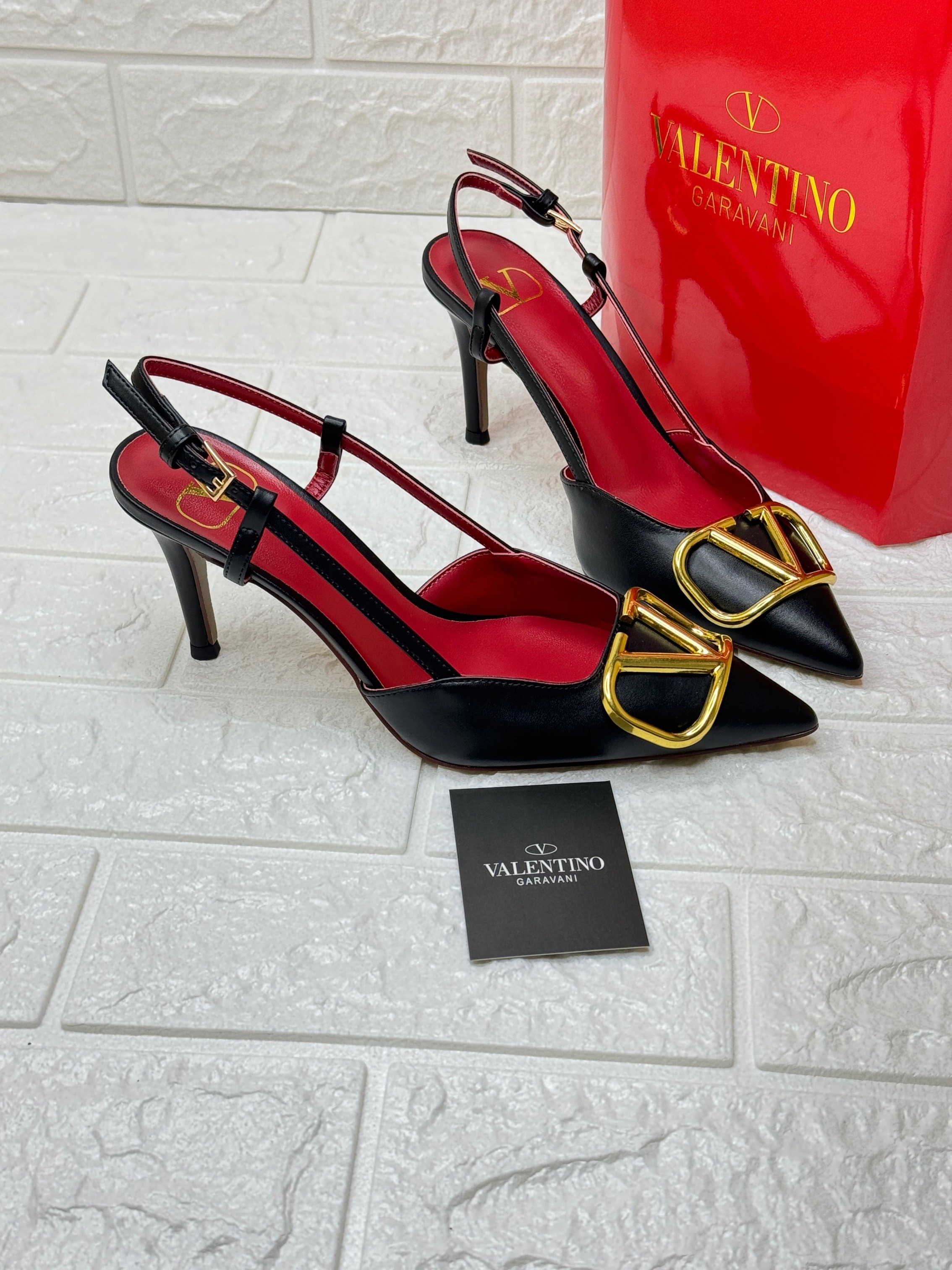 Valentino Garavani VLogo Signature slingback pumps in black calfskin leather with red insoles and gold-tone hardware. image 1