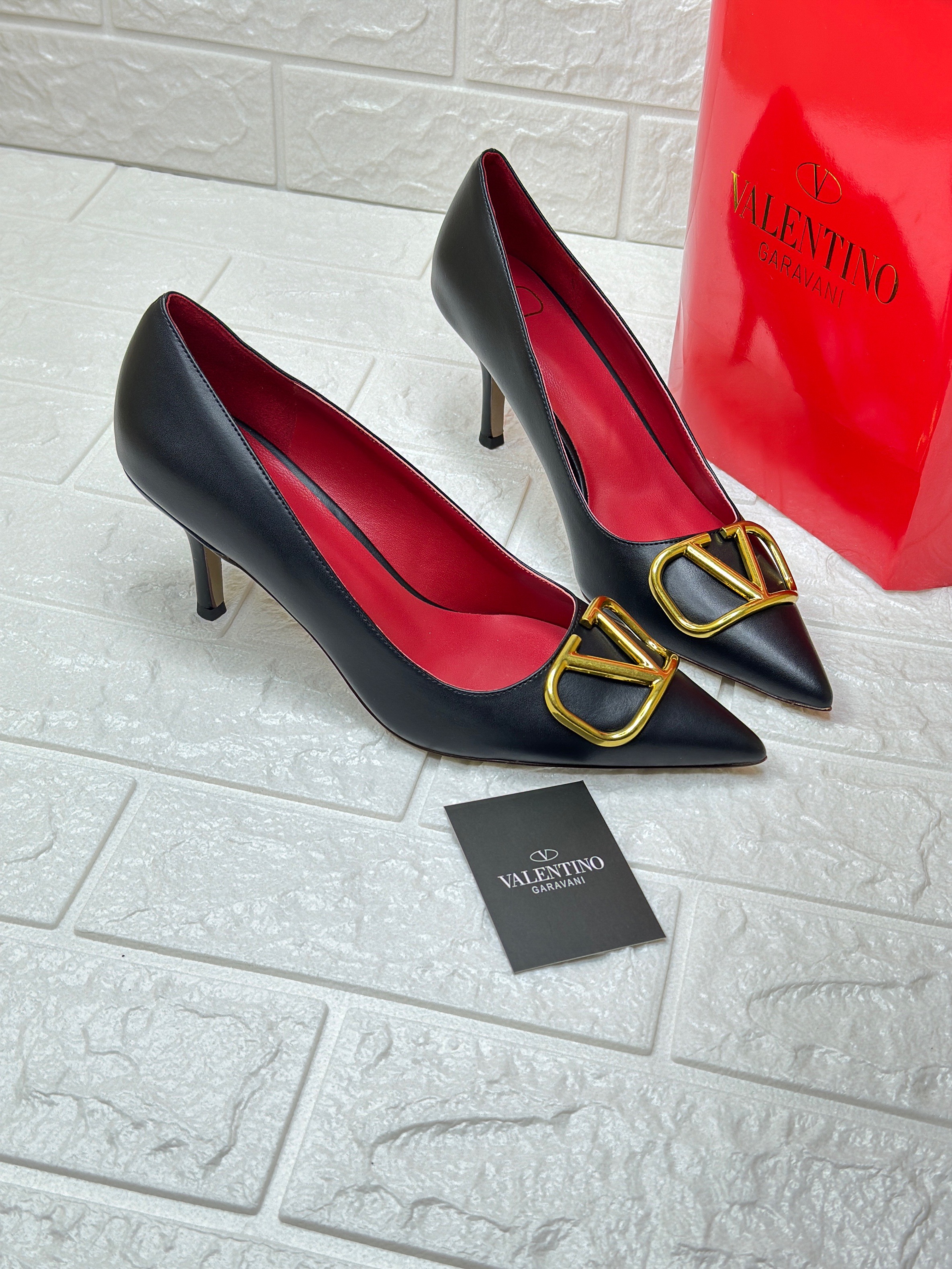 Valentino Garavani VLogo pumps with gold-toned hardware and red insoles. image 1