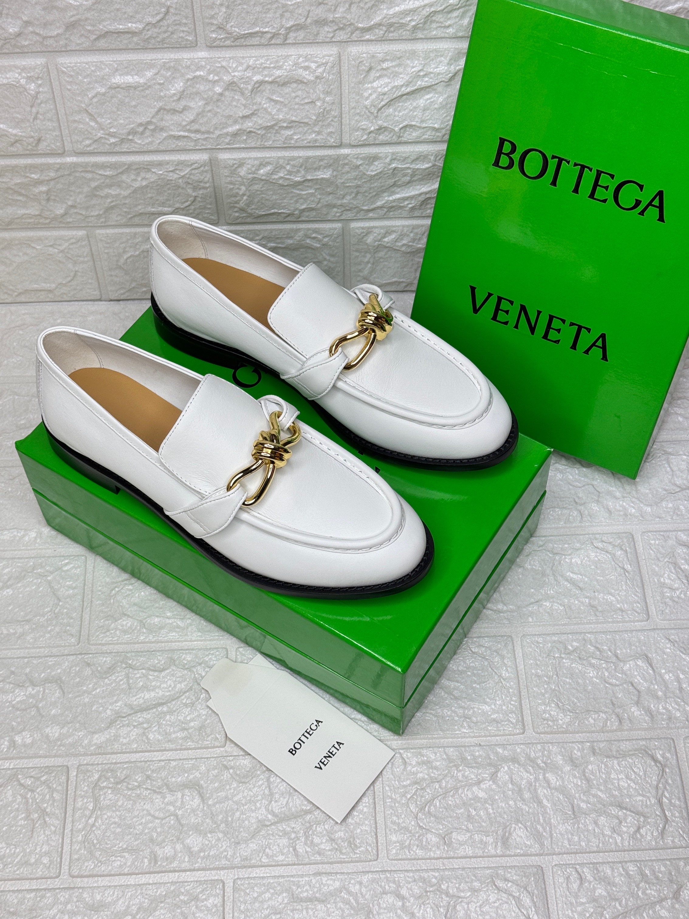 Bottega Veneta Astaire loafers featuring gold-tone knot hardware. image 1