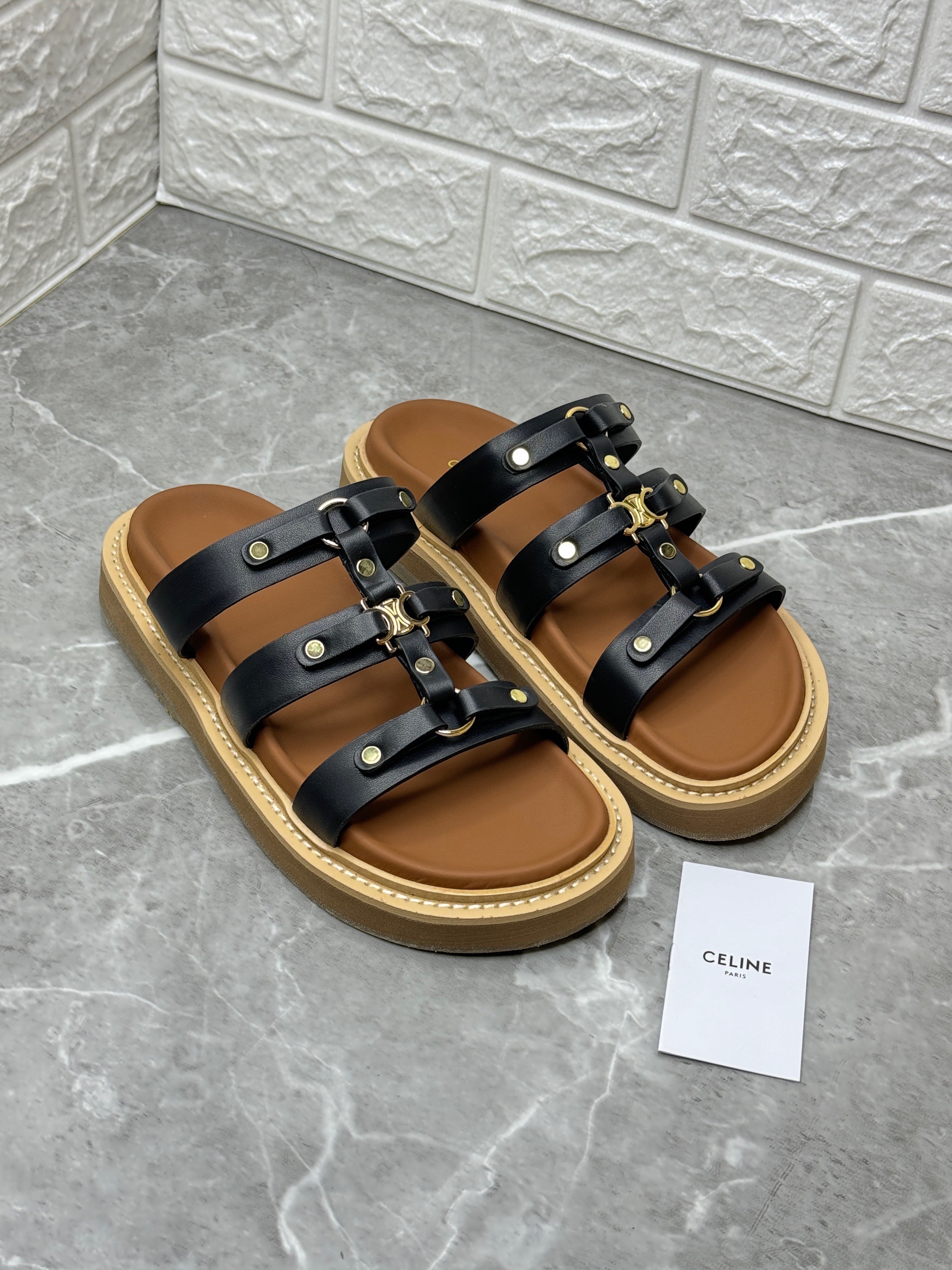 Celine Tippi Slide sandals in black calfskin with a Triomphe signature metal piece. image 1