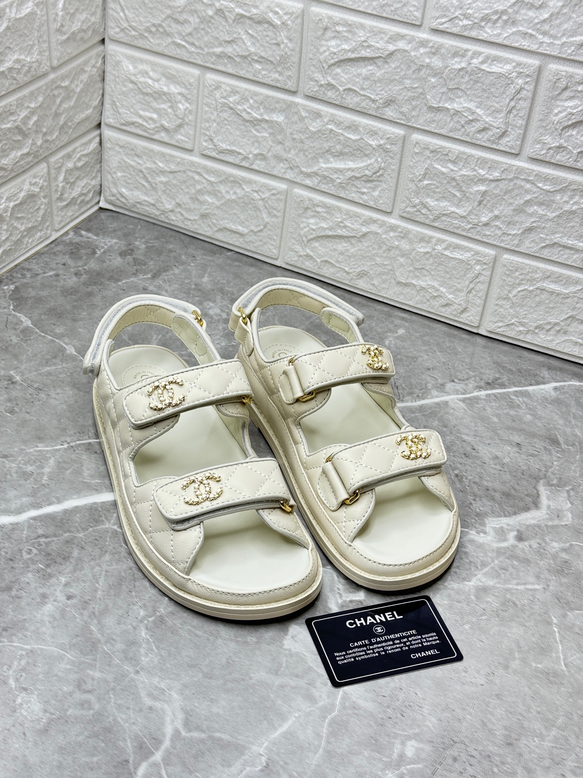 Chanel Dad sandals in white calfskin or lambskin leather with gold-tone hardware. image 1