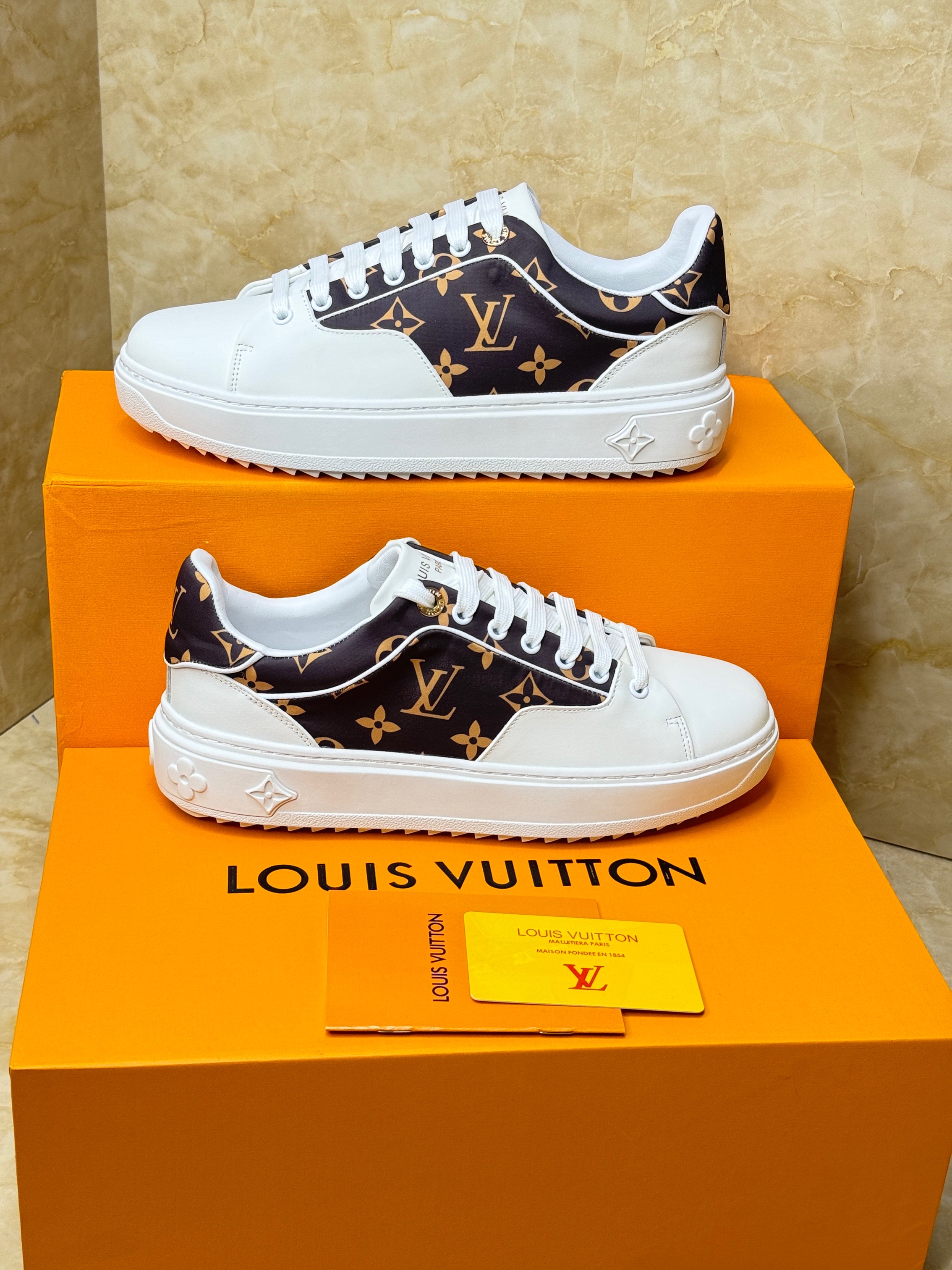 Louis Vuitton Time Out sneakers in white calf leather and Monogram canvas. The iconic design features an elevated rubber outsole with a 3D pattern of Monogram Flowers. image 1