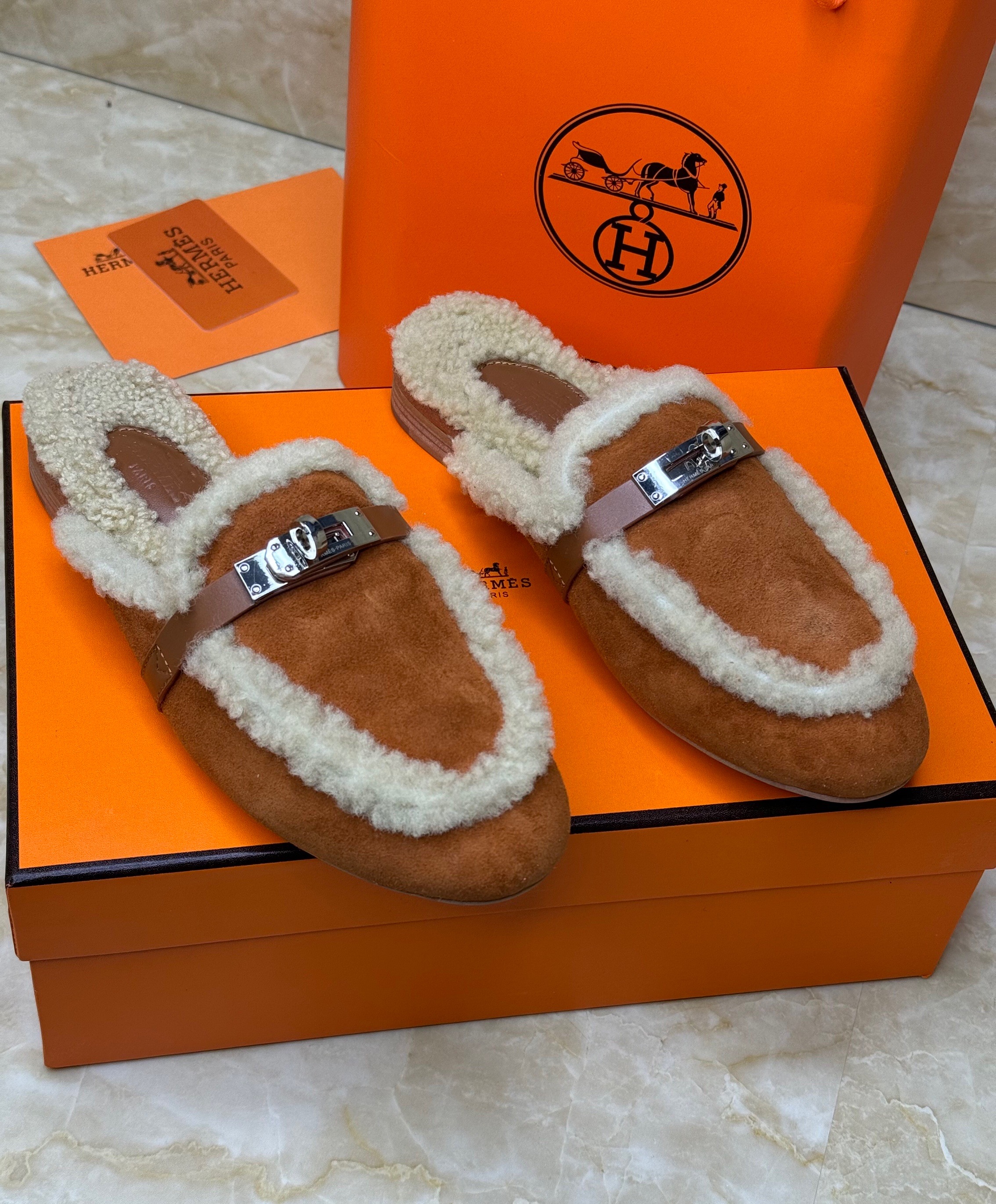 Herm?s Oz mules in natural-colored shearling and suede goatskin with palladium-plated Kelly buckles. image 1