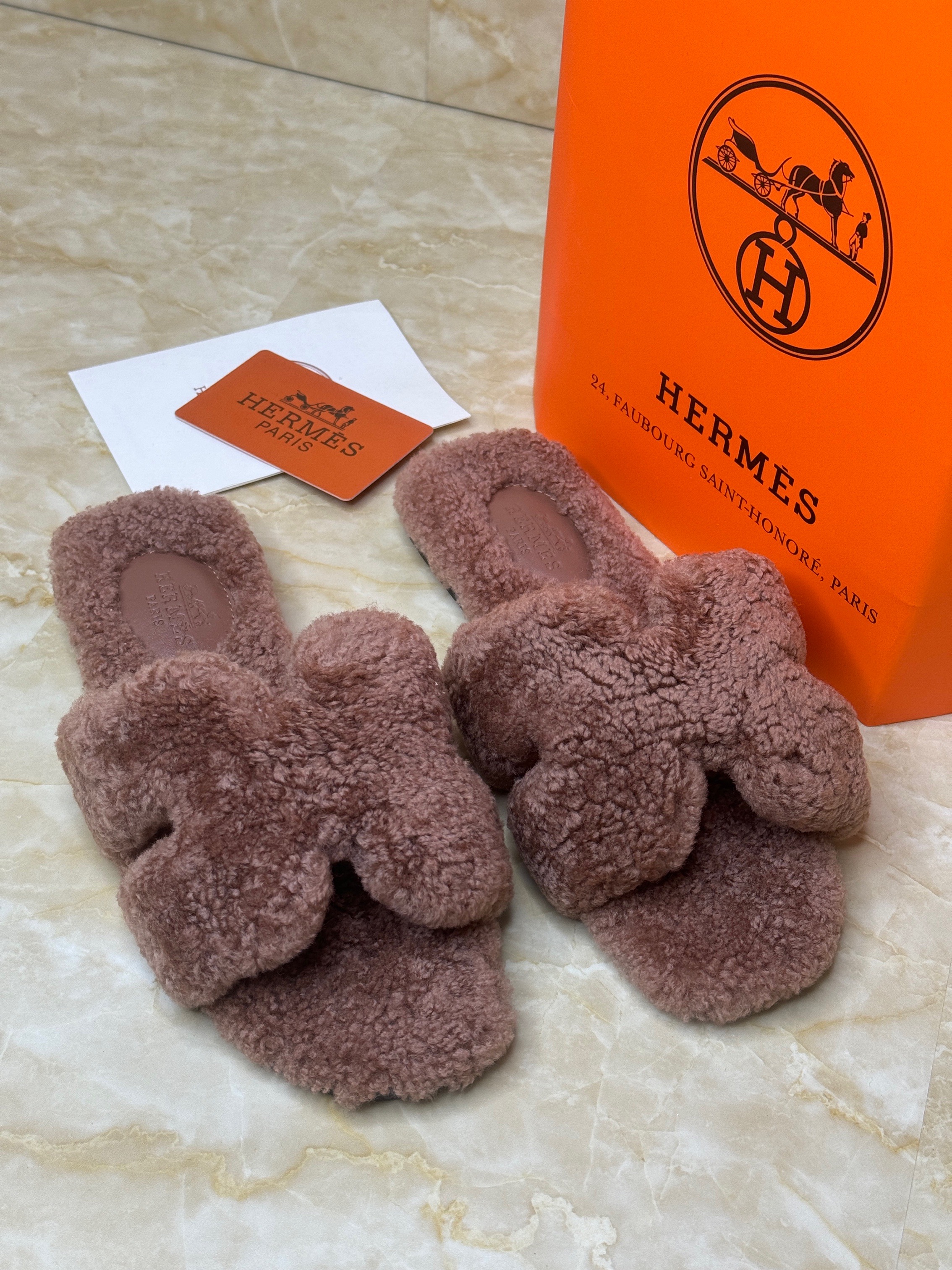 Herm?s Teddy Oran shearling sandals in a pink or rose color. image 1